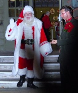 Santa waves good-bye for now as 'Clarence' stands by his side.